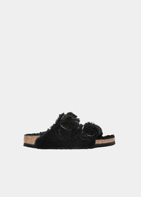 Mules Birkenstock Arizona Big Buckle Shearling en mouton noir, vue de profil – mules fourrées femme | Ann Tuil