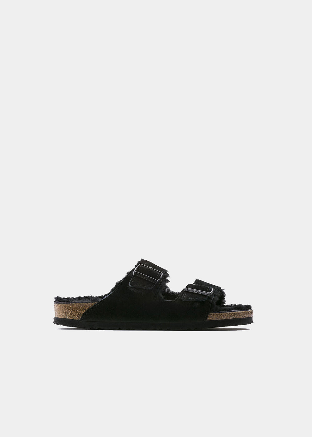 Mules Birkenstock Arizona Shearling en nubuck et fourrure noir, vue de profil – mules fourrées femme | Ann Tuil